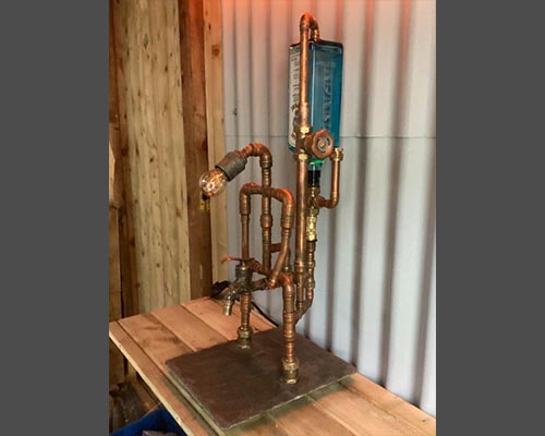 Wee'ing man spirit dispenser on slate base