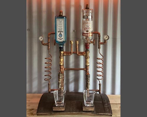 Double copper spirit dispenser on oak whiskey barrel base