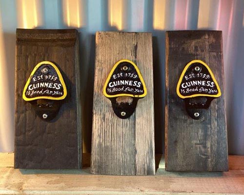 Bottle openers on oak whiskey barrel